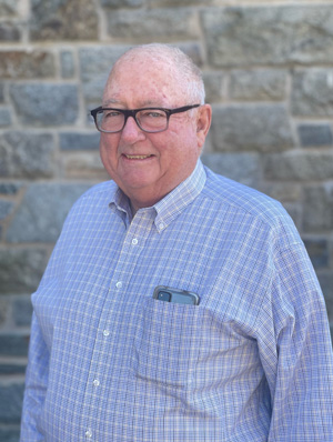 Photo of John Mooney in front of TRPB headquarters